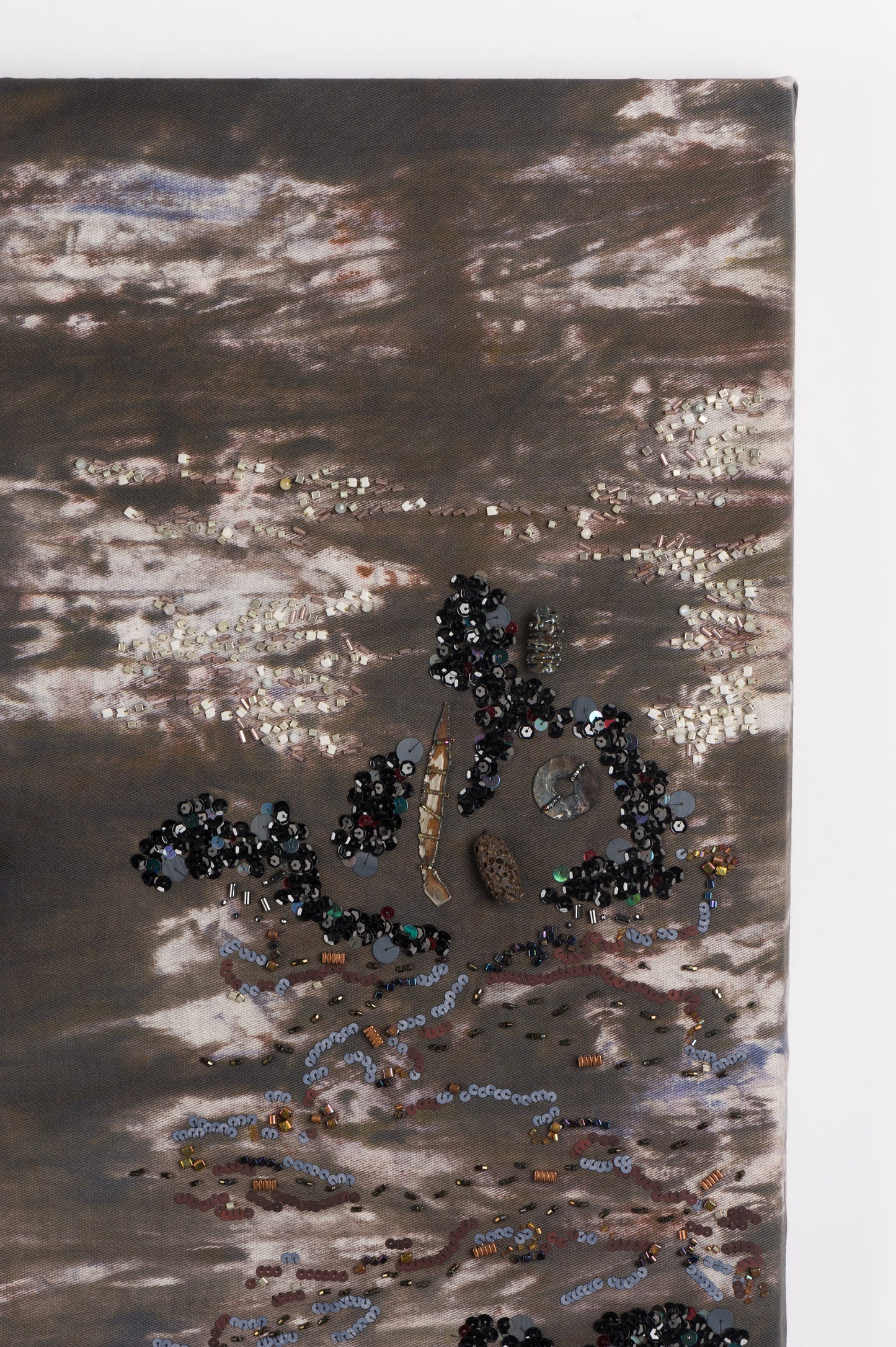 Zoom sur les détails de l'oeuvre Basa Basalt. Toile marbré et broderie main avec des fournitures métalliques et perles.